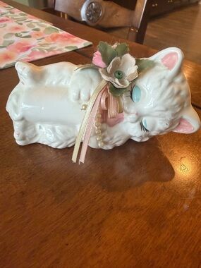 White Ceramic Sleeping Cat Figurine with Pink Accents and Floral Bow
